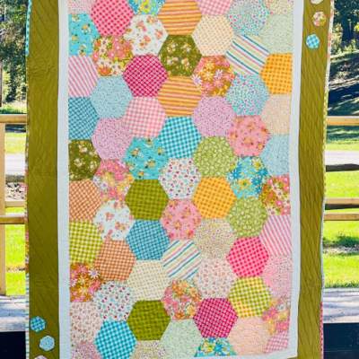 This is a one of a kind handmade quilt featuring some bright and fun high quality quilting cotton fabrics. The finished quilt is 78 1/2" x 54" which is perfect for a throw blanket on the couch or on a full size bed.