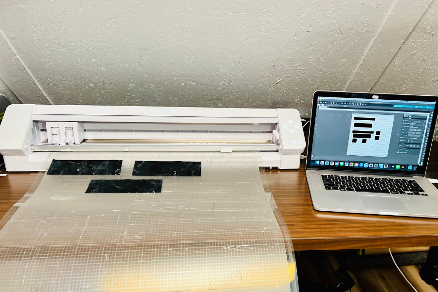 Cut files are entered in the Silhouette Design store and the fabric is loaded on the Silhouette Cameo 4 and ready to cut.