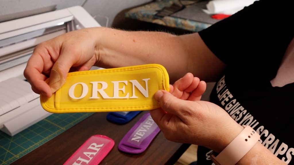 A close-up shot of a vibrant popsicle holder with a cute design made using HTV. Perfect for a refreshing summer treat!