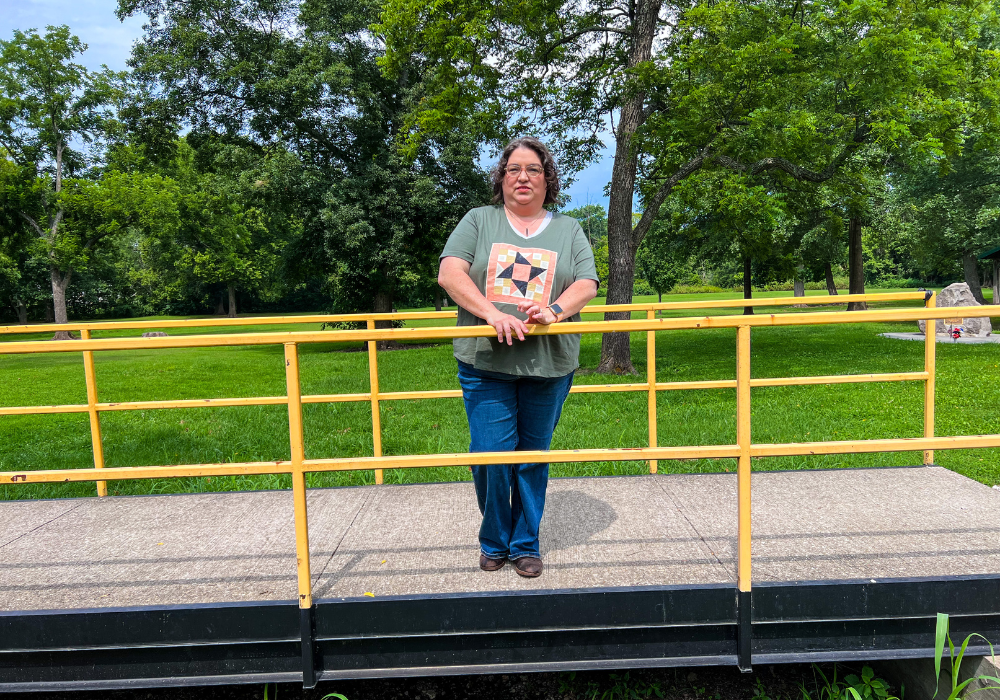 A model wearing the finished shirt with the quilt block, showcasing unique style.