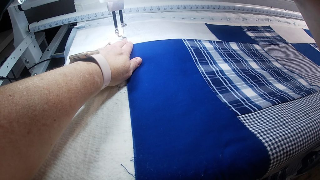 Basting the king-sized quilt to the backing and batting