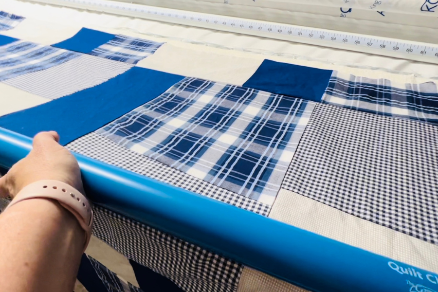 Attaching the quilt clips to the floating king-sized quilt to allow for better tension