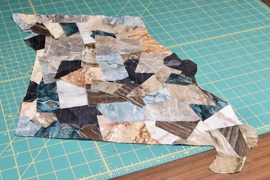 Fabric scraps cut into the shape of the state of Missouri and quilted onto interfacing using invisible thread.
