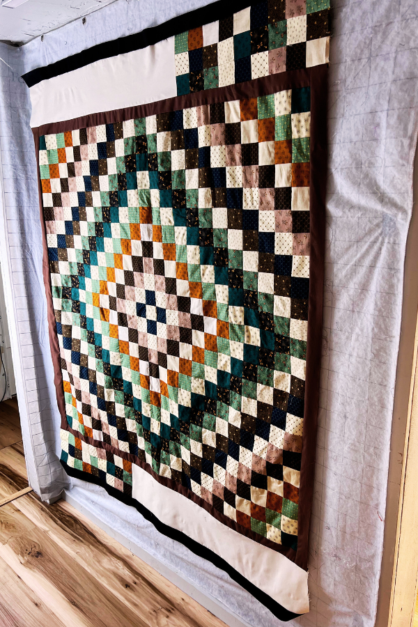 Colorful border added to a quilt using scrap fabric from the quilt top.