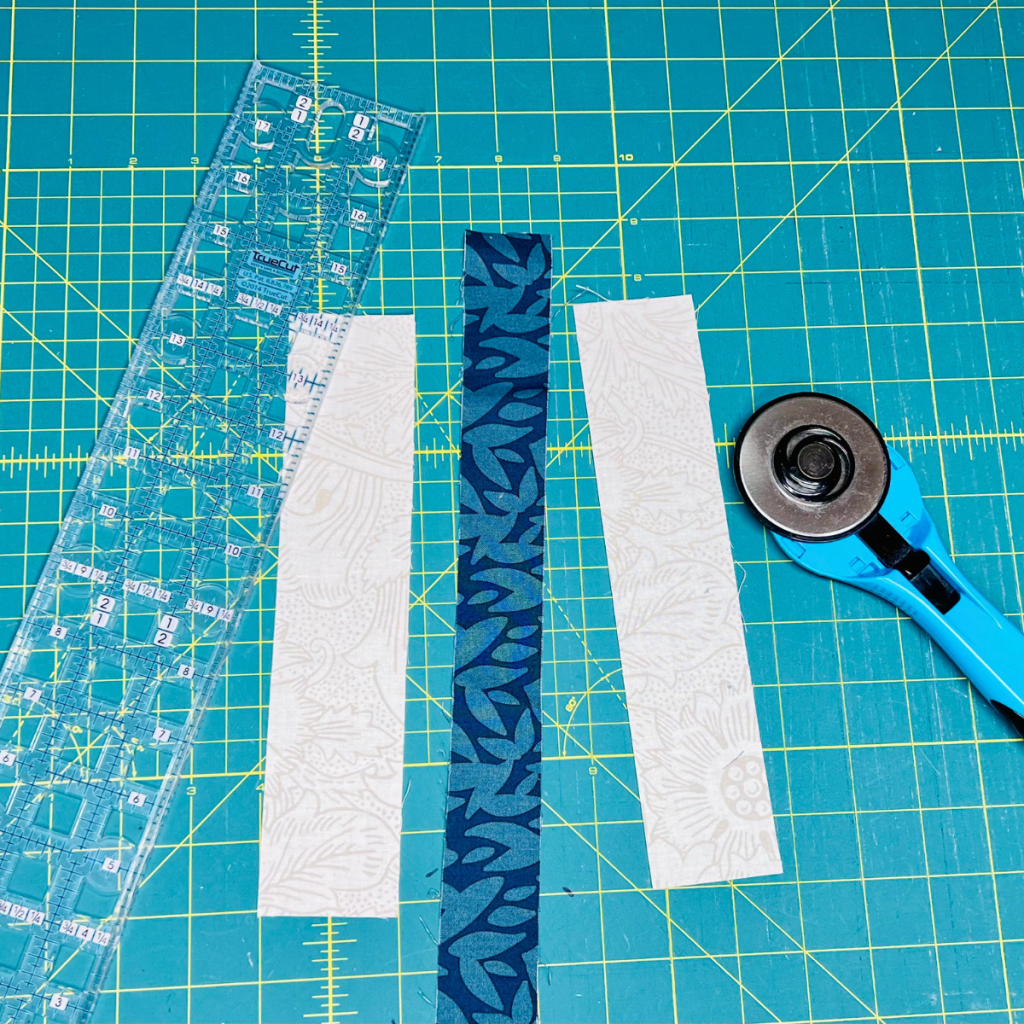 Pieces of fabric cut to make books for a bookshelf quilt.